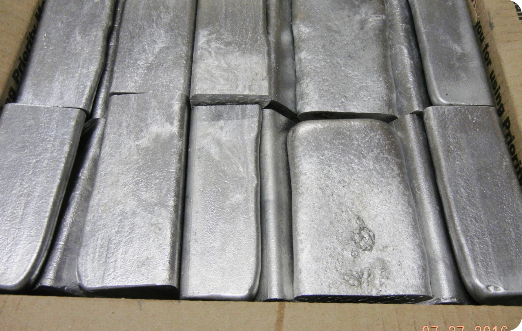 Metal bars stacked in a box